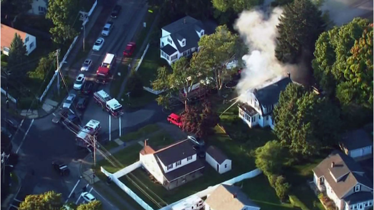 Firefighters try to put out a fire at a home in Lawrence, MA, one of many sparked by an issue with gas lines. (CNN)