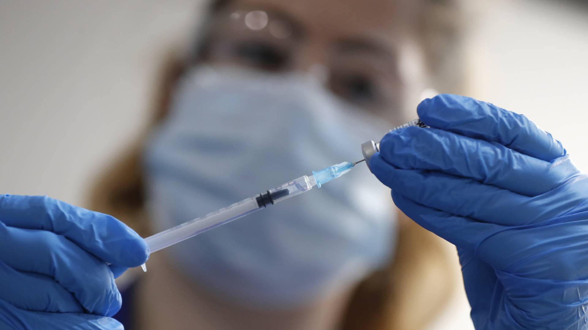 A nurse prepares a shot of the Pfizer-BioNTech COVID-19 vaccine at Guy's Hospital in London. (AP Photo/Frank Augstein, Pool)